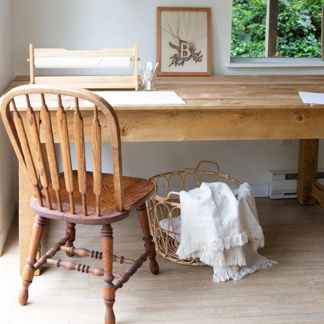 A home office featuring a desk with a natural wood look